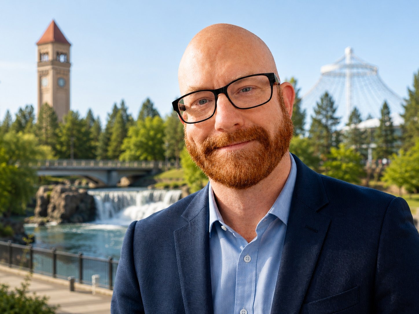 Donovan DeLeon, candidate for State Representative, with the Spokane Riverfront clock tower behind him
